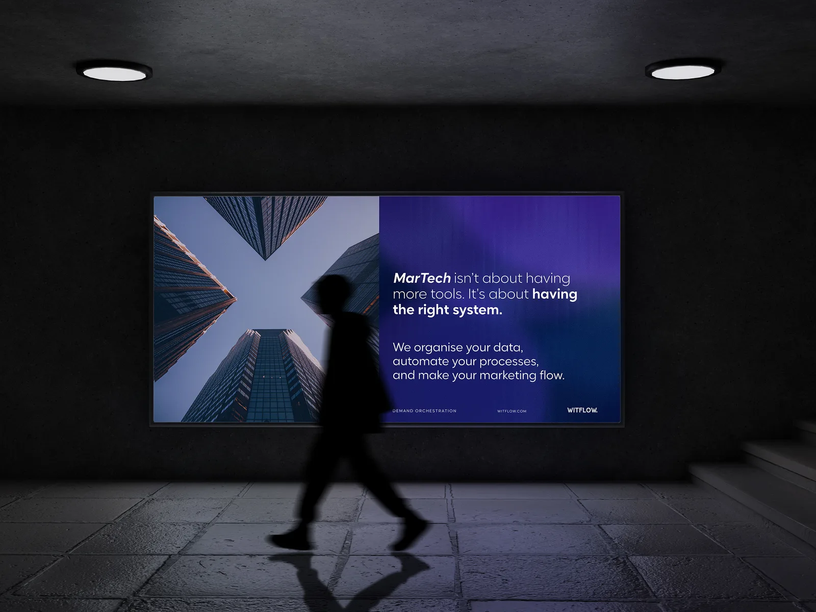 A person passing a WitFlow campaign poster in a subway